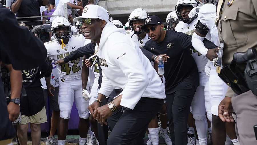 Colorado head coach Deion Sanders runs onto the field with his team for an NCAA college football game against TCU Saturday, Sept. 2, 2023, in Fort Worth, Texas. (AP Photo/LM Otero)
