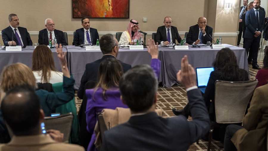 Reporters raise their hands to ask questions as Foreign Ministers, from left, Turkish Foreign Minister Hakan Fidan, Palestinian Minister of Foreign Affairs Riyad al-Maliki, Qatari Prime Minister and Minister of Foreign Affairs Sheikh Mohammed bin Abdulrahman bin Jassim Al-Thani, Saudi Foreign Minister Prince Faisal bin Farhan, Jordan's Minister of Foreign Affairs Ayman Safadi, and Egyptian Foreign Affairs Minister Sameh Shoukry, attend a news conference about the Israel-Hamas war, and pressure to reduce civilian casualties, Friday, Dec. 8, 2023, in Washington. (AP Photo/Jacquelyn Martin)